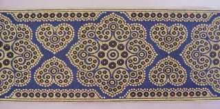Approximately 3 ¾ inches wide. This piece is 3 yards long.