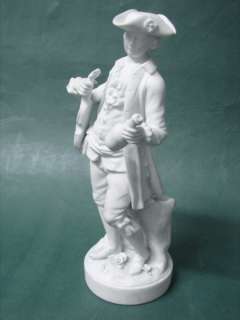  figurine of a violin musician with a wine bottle in the other