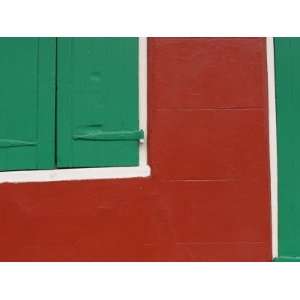  Cropped View of Green Window Shutters and Door by Red Wall 