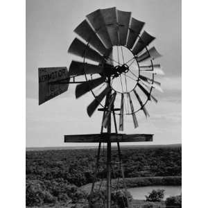  Tall Windmill Spinning High Above the Meadow and Lake 