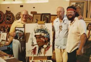 Buck Burshears and Ernesto Zepeda stand in front of Zepedas painting 