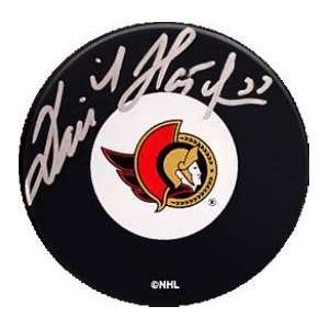 Dominik Hasek Autographed Hockey Puck   (Ottawa Senators)