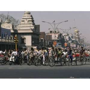  Crowds on Bikes Fill a Street Near a Bazaar and Hindu 