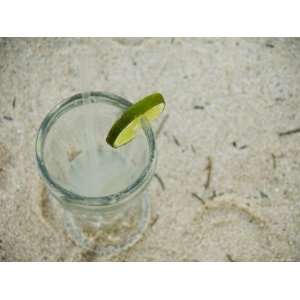  Lemonade, Lime and Straw Sitting on Sandy Beach as Seen 